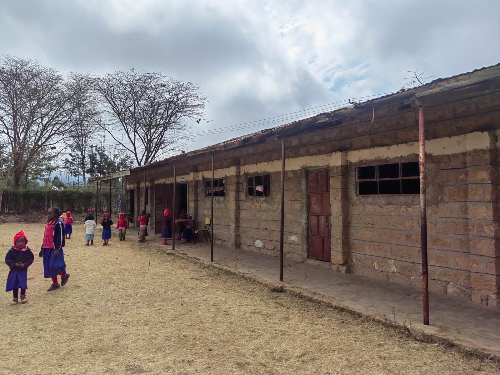School buildings and children beside an outdoor walkway